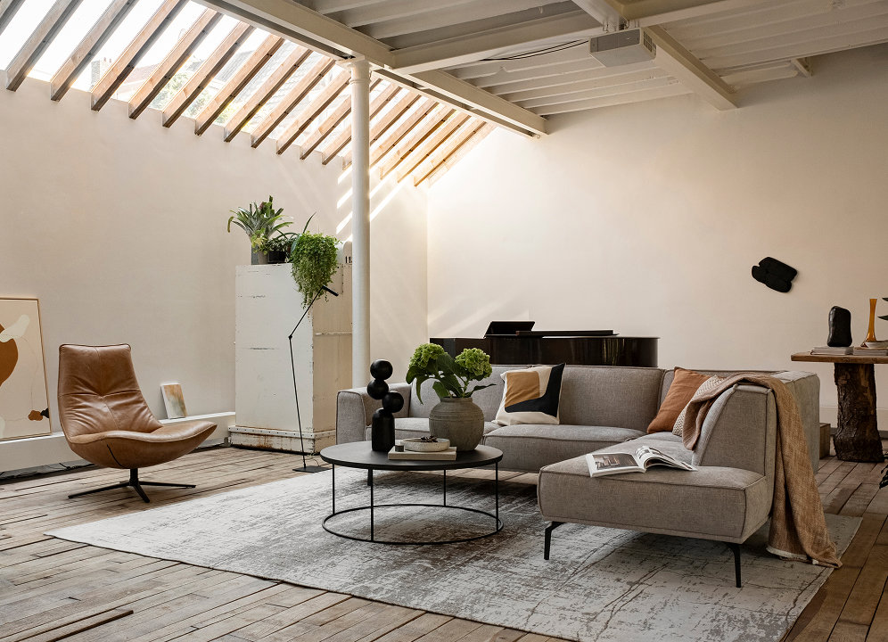 Woonkamer met hoekbank en fauteuil voor ontvangen van gezelschap